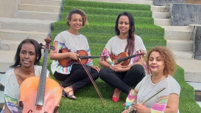 Ethio Classic Quartet by Abiyot Four women sitting on stairs holding a range of instruments