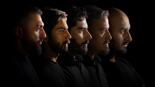 Five men in black shirts, lined up, photographed in silhouette