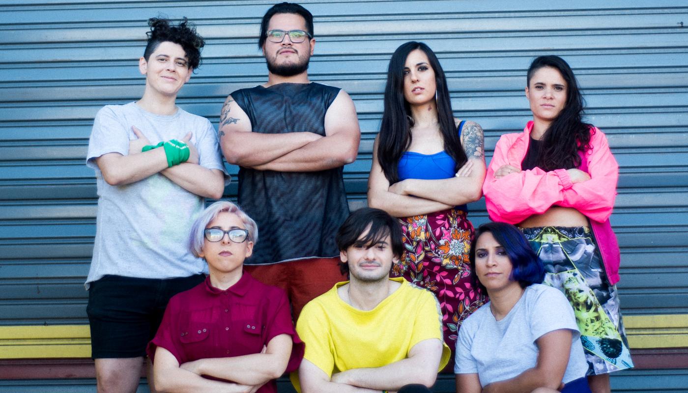 A group of 7 people standing in front of a wall