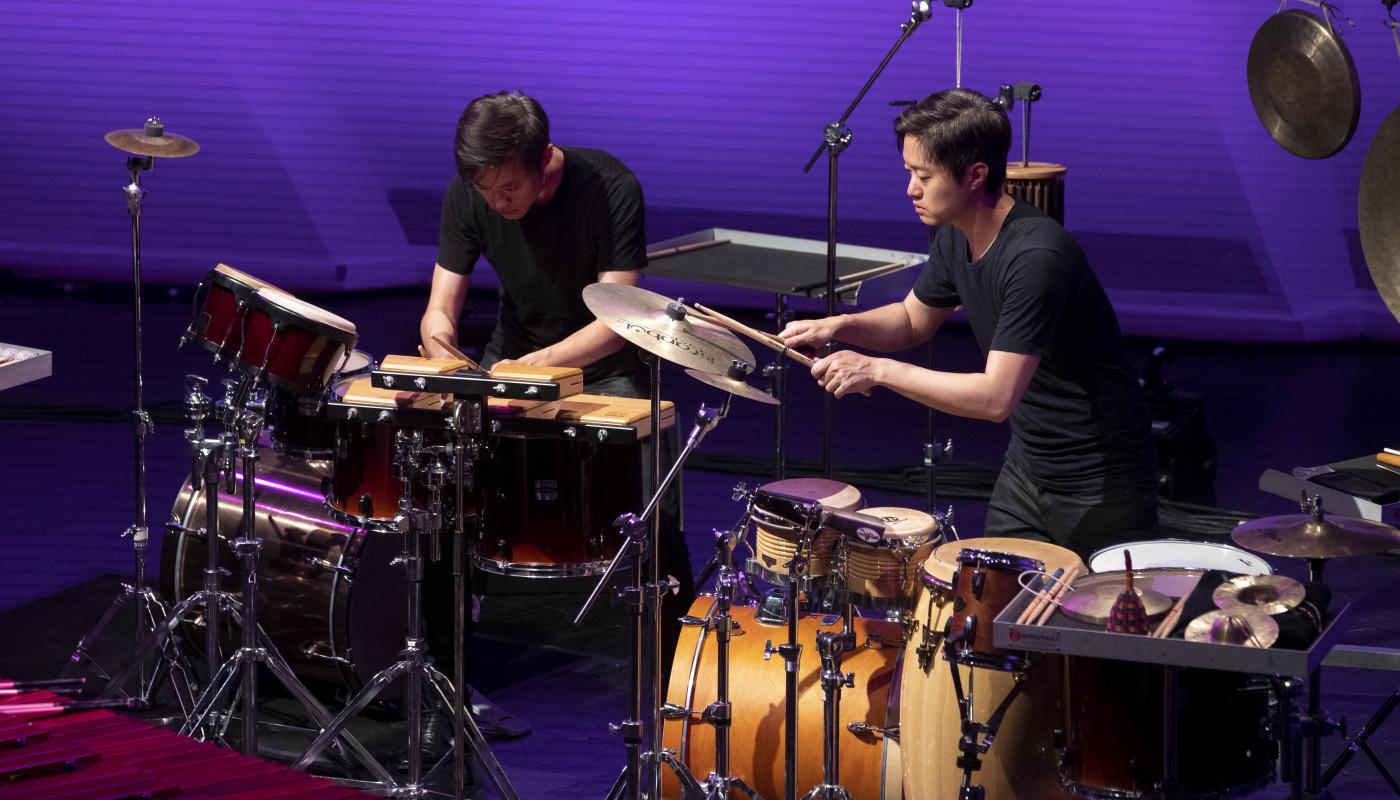 Two men on stage playing percussion instruments