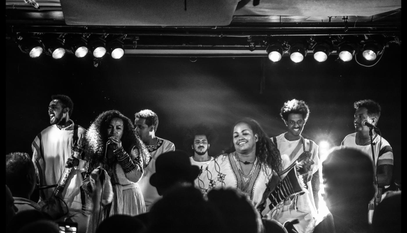 A black and white photo of musicians performing on stage