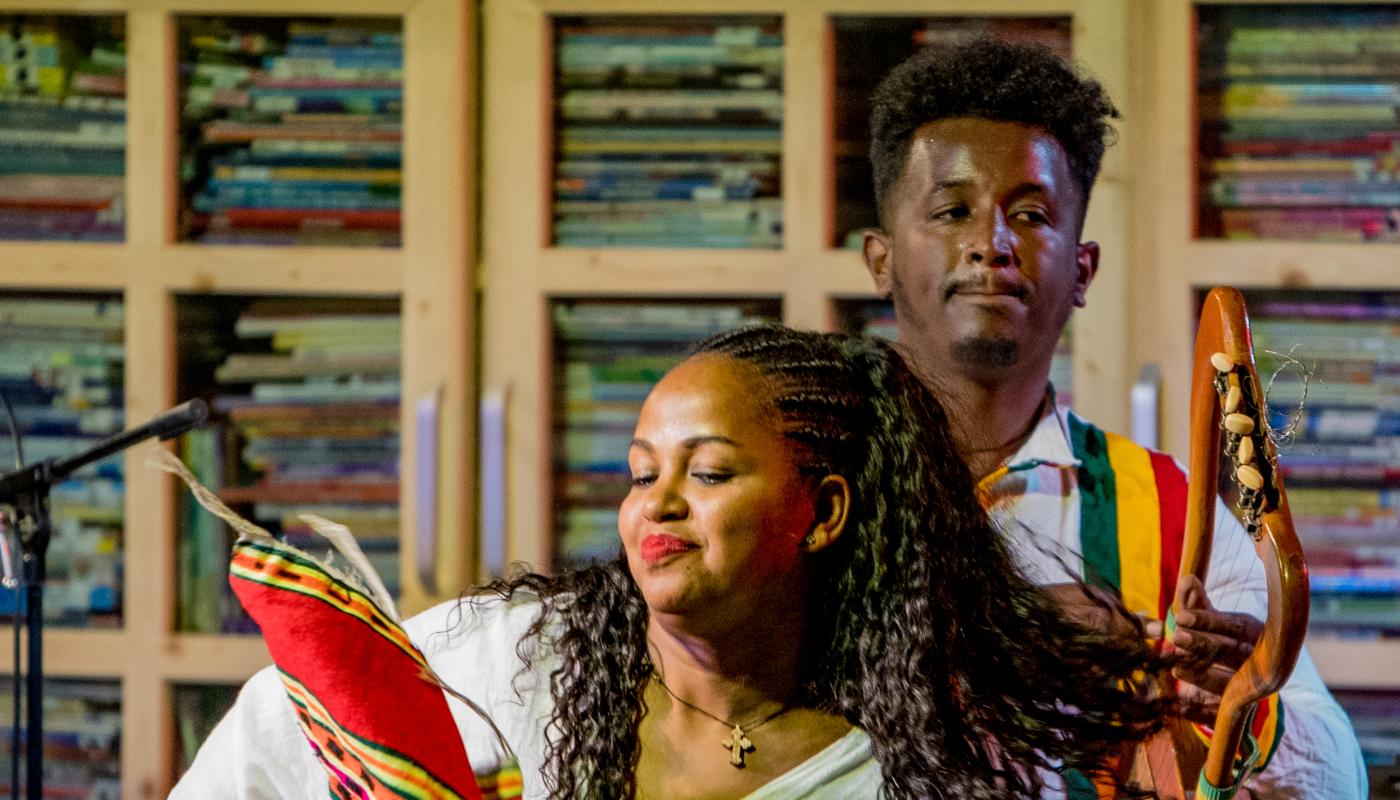 Ethiocolor by Miki Mac Two musicians performing on stage with traditional instruments