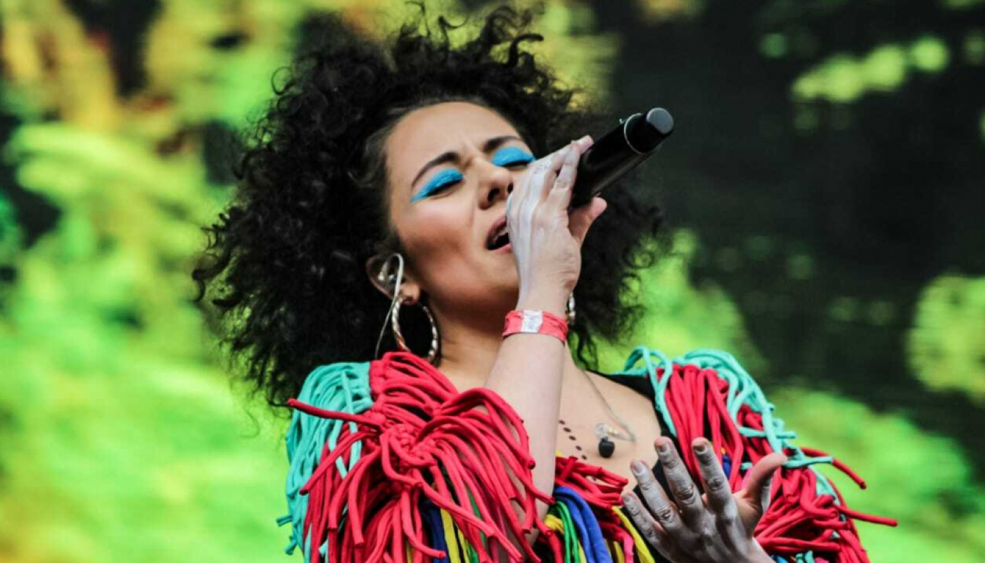 Woman singing in a brightly colored outfit