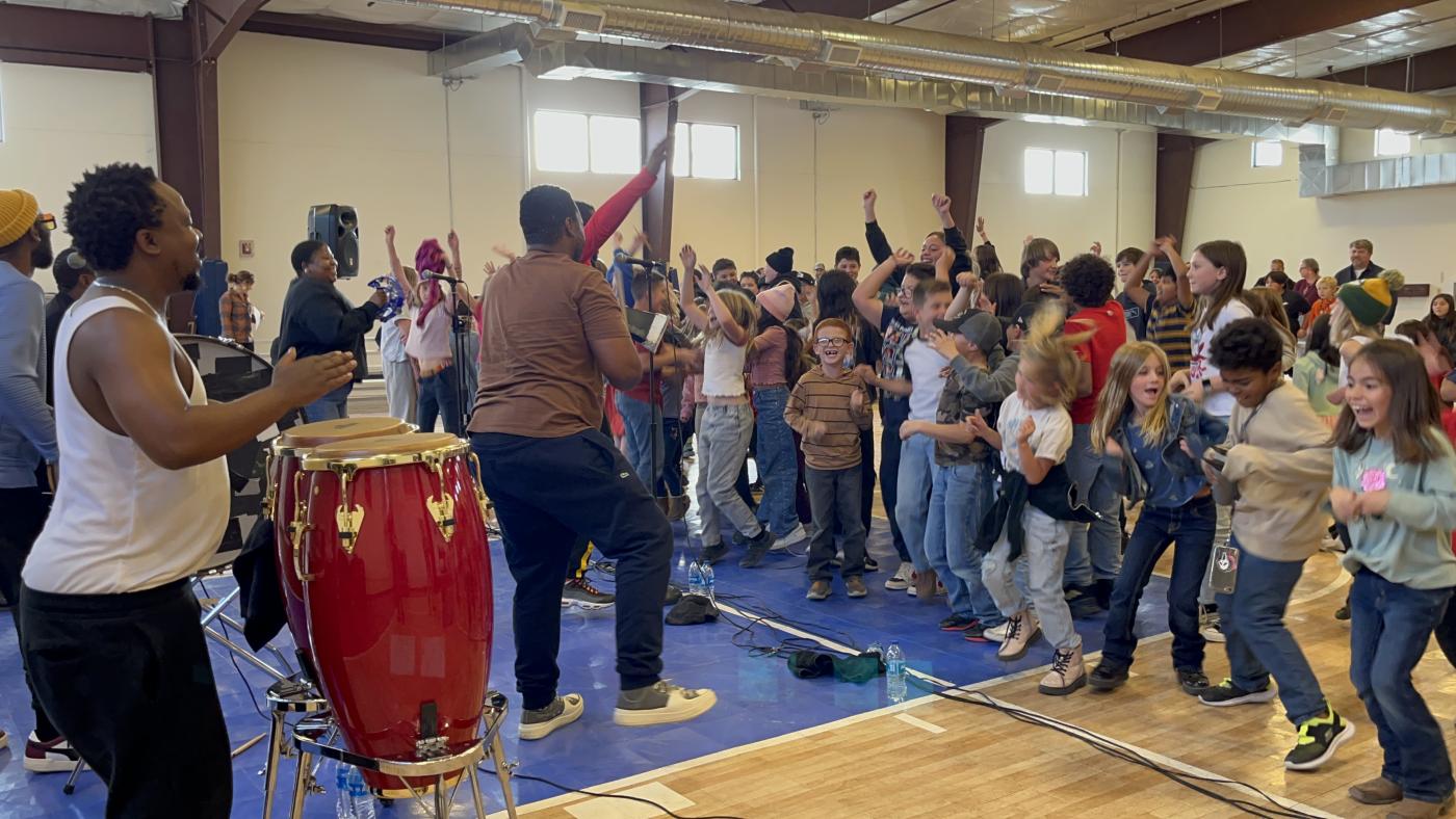A band plays for a group of young students
