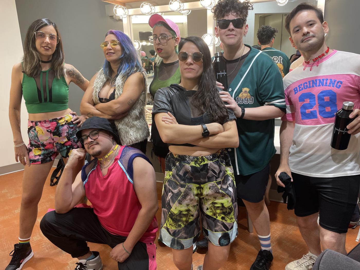 Cachitas Now! in Dayton, Ohio by Alex Zani A band of seven musicians wearing colorful street clothes pose backstage