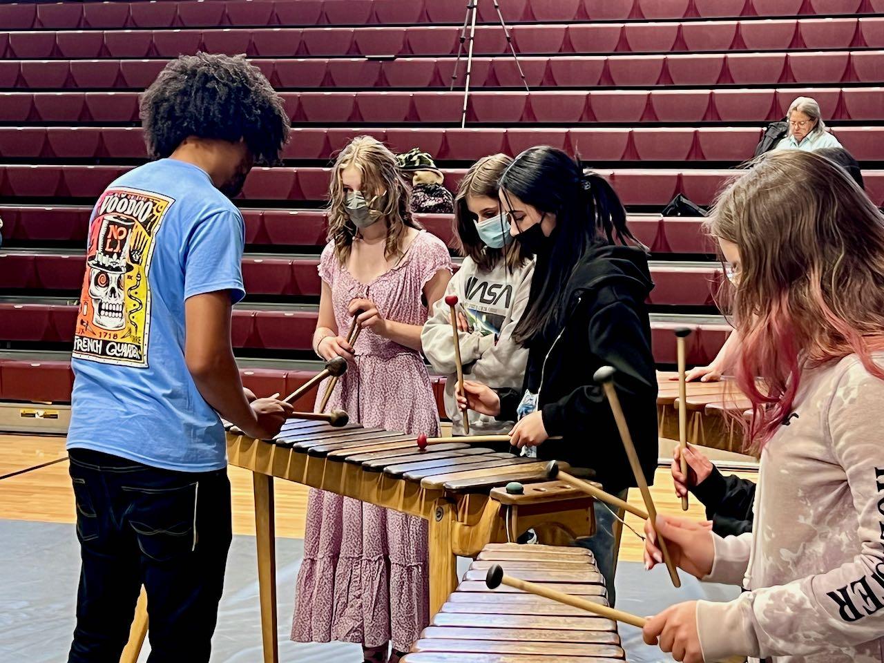 Students standing around a marimba