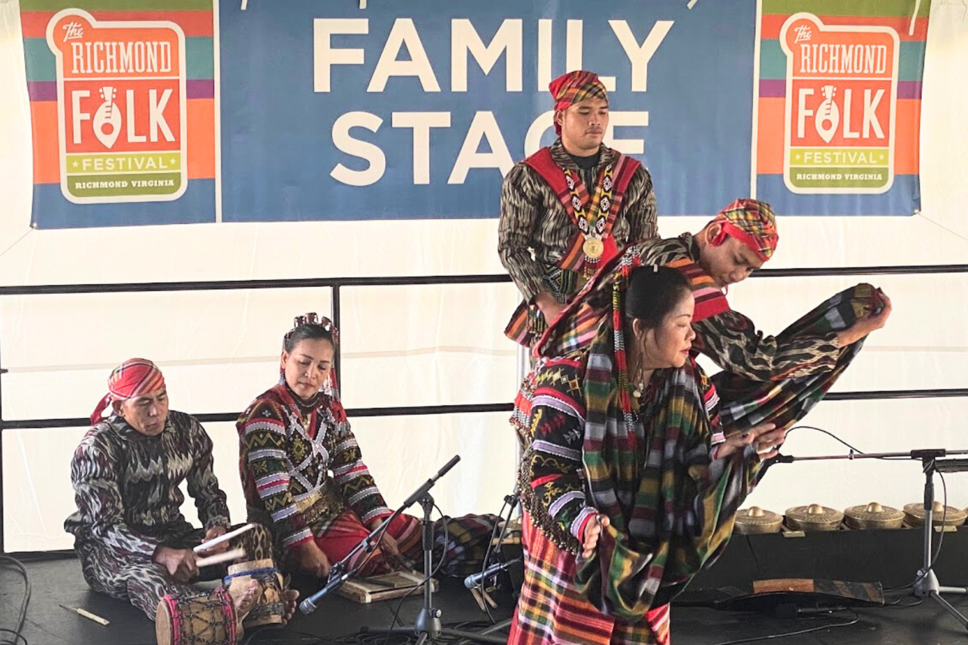 Four artists perform on a stage