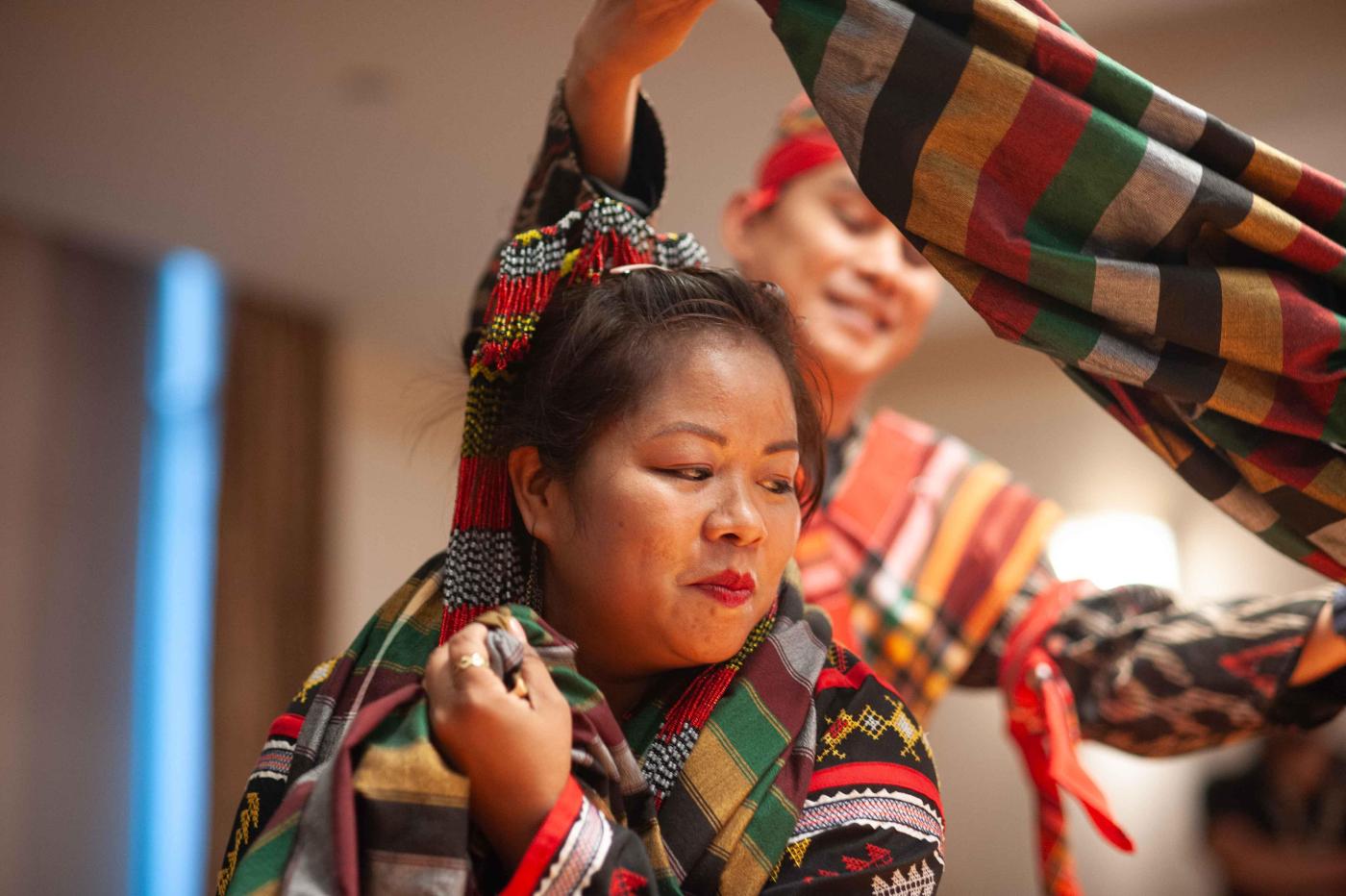 Two people perform with traditional Filipino costume