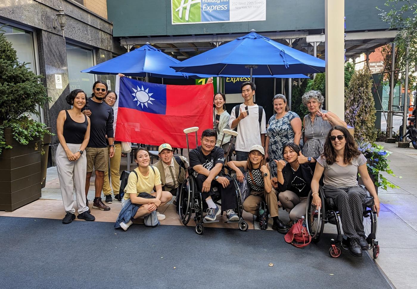 A group of people pose with a flag representing Taiwan