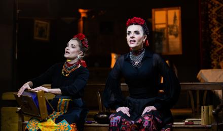 Two women performing on stage 
