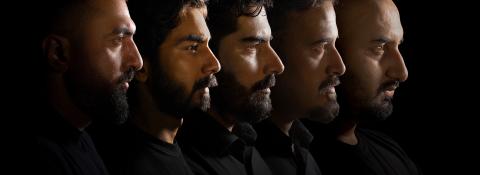 Five men in black shirts, lined up, photographed in silhouette