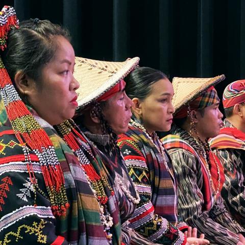 two women and three men sit on a stage in traditional Tboli clothing