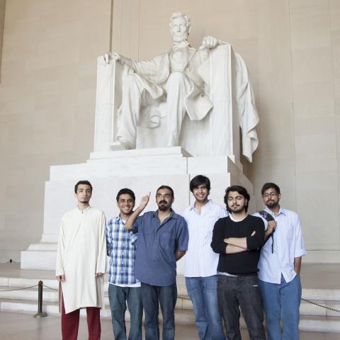 A group of men standing in front of the Lincoln Memorial