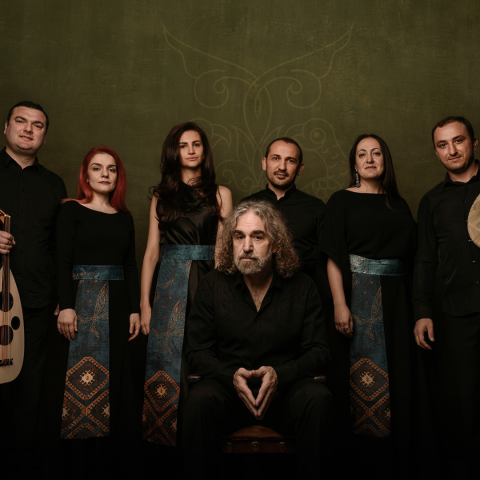 The Naghash Ensemble by David Galstyan Six people standing together with one man sitting in front