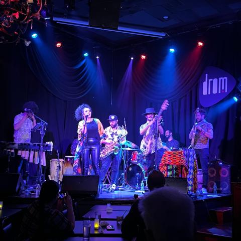 A band performs on stage in a nightclub